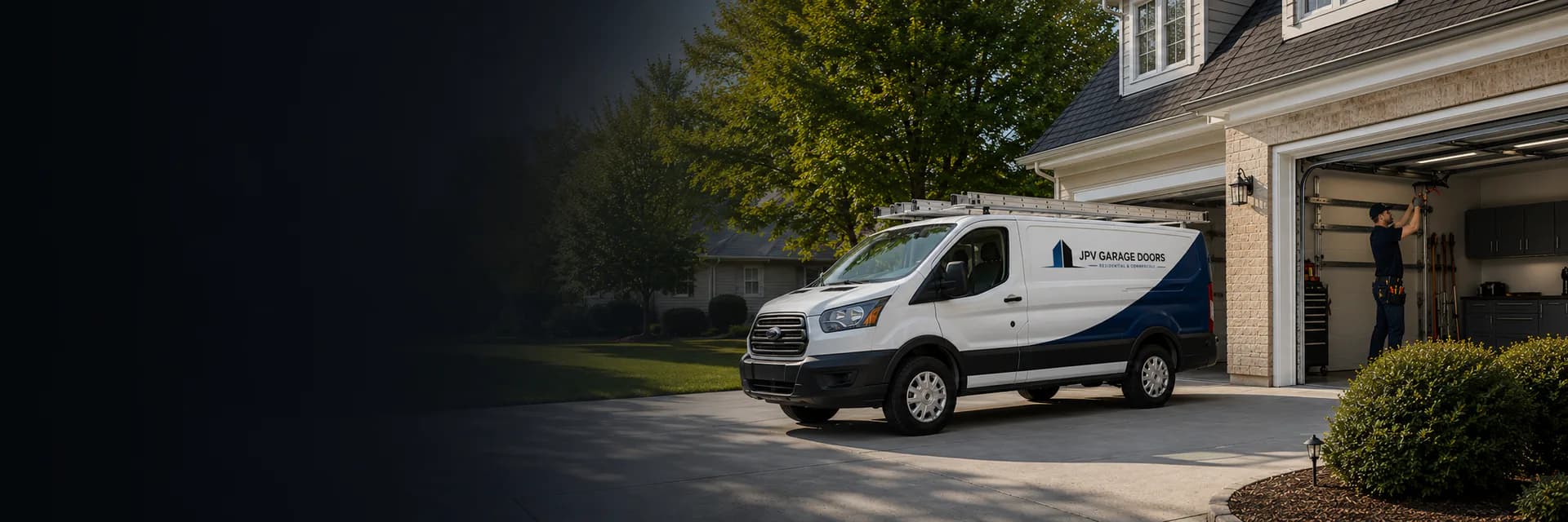 Garage door service technician working beside a service vehicle